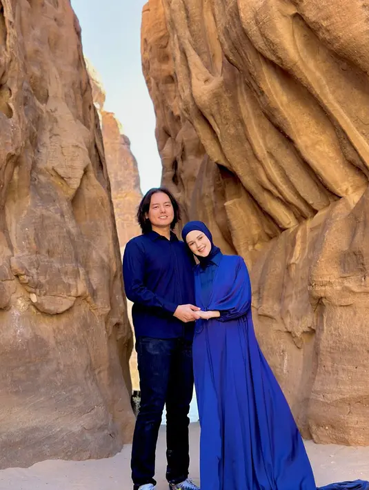 Berpose dengan latar tebing di Al Ula, keluarga Roger dan Cut tampil kompak kenakan ansambel serba biru. [@risiko cutratumey].