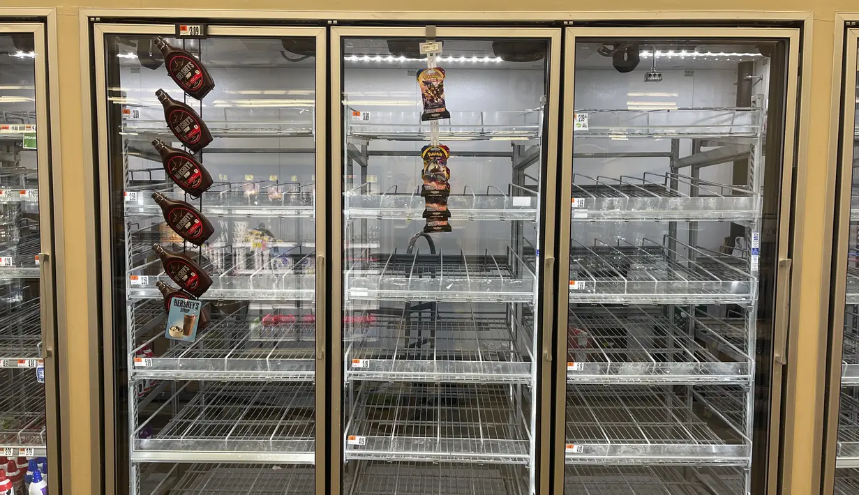 Rak susu sebagian besar kosong di toko kelontong Giant, Washington, Selasa (11/1/2022). Varian Omicron yang sangat menular membuat pekerja sakit, menciptakan kekurangan tenaga kerja yang memengaruhi pengiriman produk dan pengisian kembali rak-rak toko di seluruh negeri. (AP Photo/Parker Purifoy)