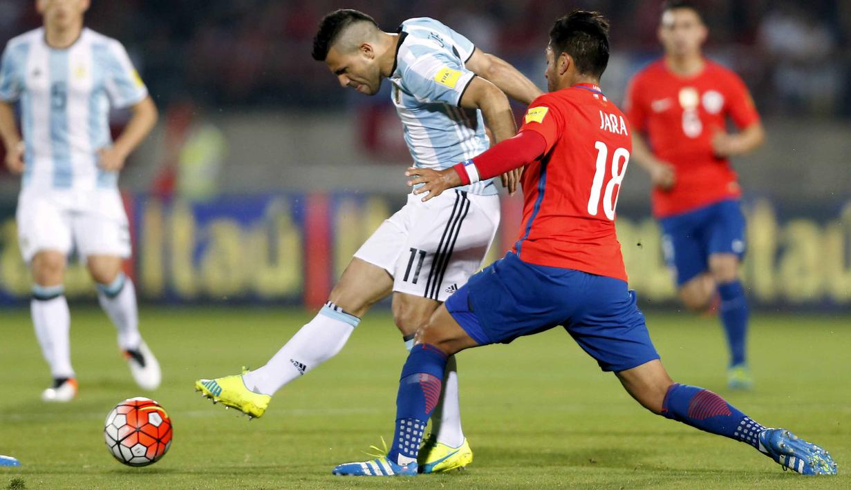 Sergio Aguero melepaskan temakan dari hadangan pemain Cile pada laga kualifikasi Piala Dunia 2018 zona CONMEBOL di Stadio Nacional Julio Martinez Pradanos, Santiago, Jumat (25/3/2016) WIB.  (REUTERS/Rodrigo Garrido)