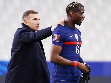 Pelatih Ukraina, Andriy Shevchenko, bercengkrama dengan gelandang Prancis, Paul Pogba, pada laga Kualifikasi Piala Dunia di Stadion Saint Denis, Paris, Kamis (25/3/2021). Kedua tim bermain imbang 1-1. (AFP/Franck Fife)