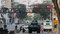 Kendaraan lapis baja Garda Nasional memblokir sebuah jalan yang mengarah ke Istana Kepresidenan Miraflores di Caracas, Venezuela, Sabtu, (3/1/2026) di tengah eskalasi ketegangan pasca penangkapan Presiden Nicolas Maduro dan istri oleh Amerika Serikat. (Dok. AP/Cristian Hernandez)