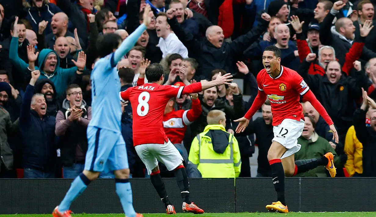 Bek Manchester United, Chris Smalling (kanan)merayakan selebrasi usai mencetak gol ke gawang City saat Laga Liga Premier Inggris di Old Trafford, Minggu (12/4/2015). Manchester United menang 4-2 atas City. (Reuters/Darren Staples)