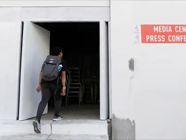 Seorang pria masuk ke dalam media center dari Stadion Rizal Memorial di Manila, Filipina, Senin (25/11/2019). Meski akan digunakan untuk ajang SEA Games 2019, kondisi ruangannya sangat memprihatinkan. (Bola.com/M Iqbal Ichsan)