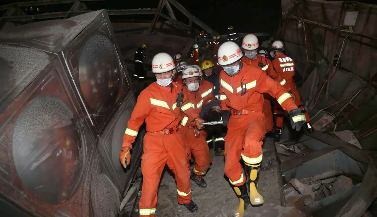 Tim penyelamat mengevakuasi orang yang terluka dari hotel tempat karantina virus corona yang runtuh di Quanzhou di provinsi Fujian, China, Sabtu (7/3/2020). Saksi mata yang tinggal tidak jauh dari lokasi mendengar dentuman keras saat makan malam yang dikiranya suara ledakan. (Chinatopix Via AP)