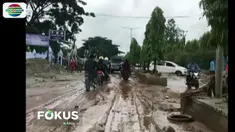 Selain lumpur di kanan kiri jalan, juga terlihat batang kayu yang terbawa saat banjir bandang.