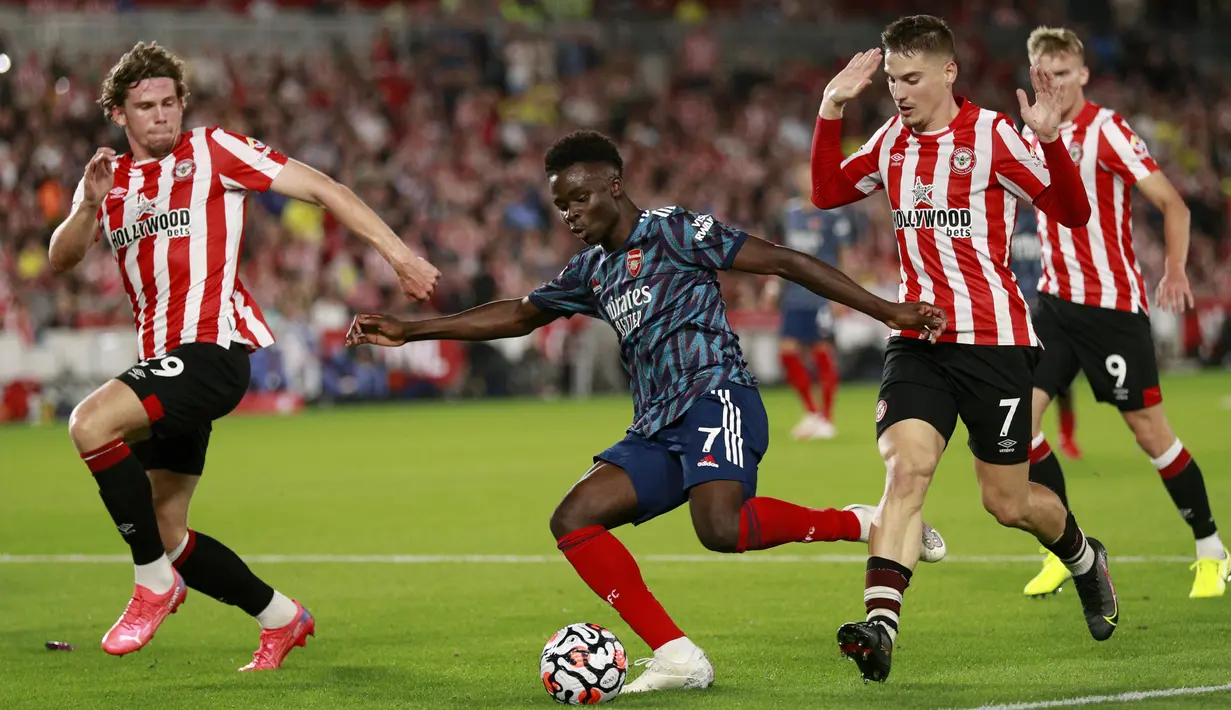 Gelandang Arsenal Bukayo Saka melakukan tembakan saat melawan Brentford pada laga pembuka Liga Inggris 2021/2022 di Brentford Community Stadium, Sabtu (14/8/2021) dini hari WIB. The Gunners tak berdaya dan takluk 0-2 dari Brentford. (AP photo/Ian Walton)