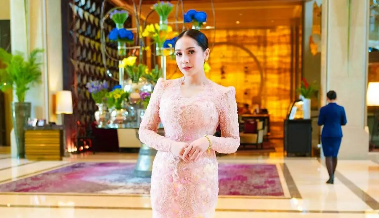 Nagita Slavina memadukan kebaya brokat dengan desain klasik berwarna merah muda, dengan kain songket berwarna kuning dan sentuhan warna merah muda yang senada. [Foto: Instagram/pecintaladygigi]