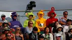 Penonton mengenakan kostum Teletubbies menyaksikan pertandingan antara  Adrian Mannarino dari Prancis melawan pemain Kroasia Marin Cilic selama babak pertama tunggal putra hari kedua Kejuaraan Wimbledon 2019 di All England Lawn Tennis Club di Wimbledon, London (2/7/2019). (AFP Photo/Adrian Dennis)