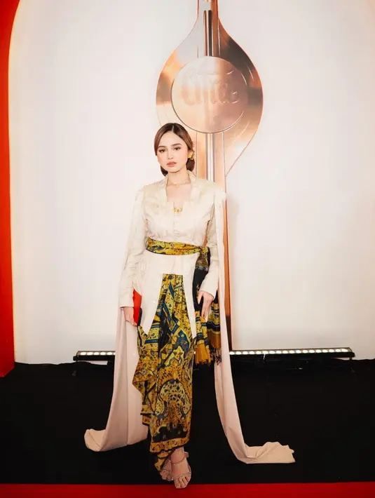 Penampilan Syifa Hadju selalu menarik untuk disimak. Di malam FFI 2023, Syifa tampil super elegan dengan kebaya bersiluet kutubaru bernuansa keemasan. Detail manis berupa cape di bagian bahu kanan-kirinya menjuntai hingga ke lantai. Ia padukan penampilannya dengan kain batik sebagai selendang yang dililitkannya di pinggang dan bawahan. [Foto: Instagram/syifahadju]