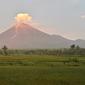 Gunung Semeru menyemburkan asap tipis terlihat dari desa Curah Kobokan di Lumajang, Jawa Timur, Rabu (8/12/2021).  Usai meletus pada Sabtu 4 Desember 2021, Gunung Semeru yang terletak di Lumajang tersebut berstatus level 2 waspada. (ADEK BERRY / AFP)
