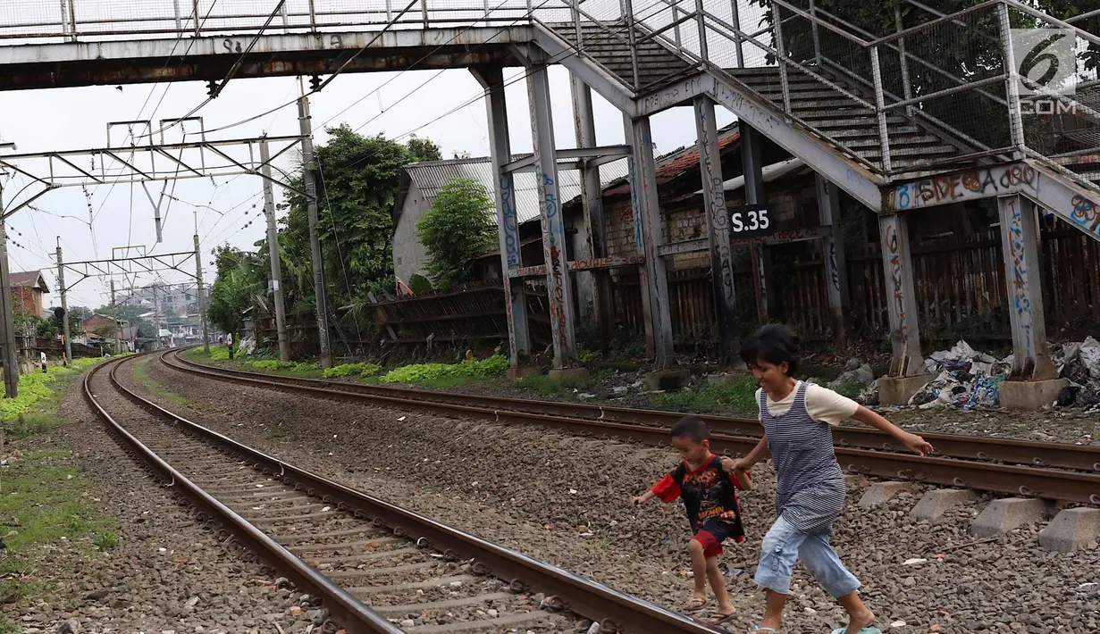 Warga melintas di bawah JPO berkarat dan tidak terawat di kawasan Tebet, Jakarta, Selasa (6/3). Kondisi JPO yang memprihatinkan menyebabkan sebagian warga memilih untuk tidak menggunakannya karena membahayakan keselamatan. (Liputan6.com/Immanuel Antonius)
