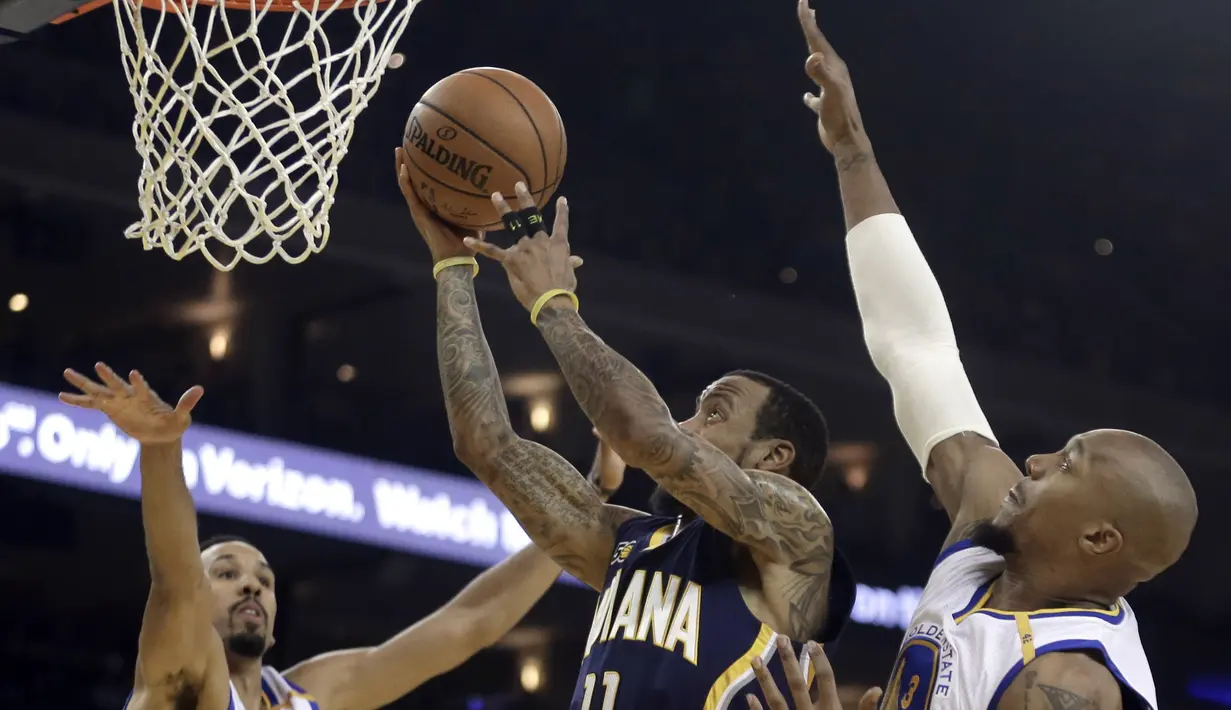 Pemain Indiana Pacers, Monta Ellis (tengah) melakukan tembakan saat dihadang para pemain Warriors  pada laga NBA Oracle Arena,Oakland, California, (5/12/2016). (AP/Ben Margot)
