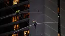 Aerialists Nik Wallenda (kanan) dan saudara perempuannya Lijana Wallenda melintasi seutas kawat di ketinggian 396 meter, Times Square, New York, AS, Minggu (23/6/2019). Aksi berbahaya ini bertajuk Highwire Live In Times Square. (AP Photo/Jason Szenes)