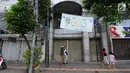 Pejalan kaki melintas di depan pertokoan yang tutup di Jalan Sabang, Jakarta pada Rabu (22/5/2019). Pemilik toko dan pengelola kantor di kawasan tersebut menutup toko dan kantor mereka imbas aksi 22 Mei 2019 yang berakhir rusuh di beberapa titik lokasi. (Liputan6.com/Aangga Yuniar)