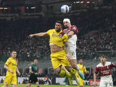 Penyerang AC Milan, Zlatan Ibrahimovic (kanan) berebut bola udara dengan pemain Bologna, Kevin Bonifazi pada pertandingan lanjutan Liga Serie A Italia di stadion San Siro, di Milan, Italia, Selasa (5/4/2022). AC Milan bermain imbang atas Bologna 0-0. (AP Photo/Antonio Calanni)