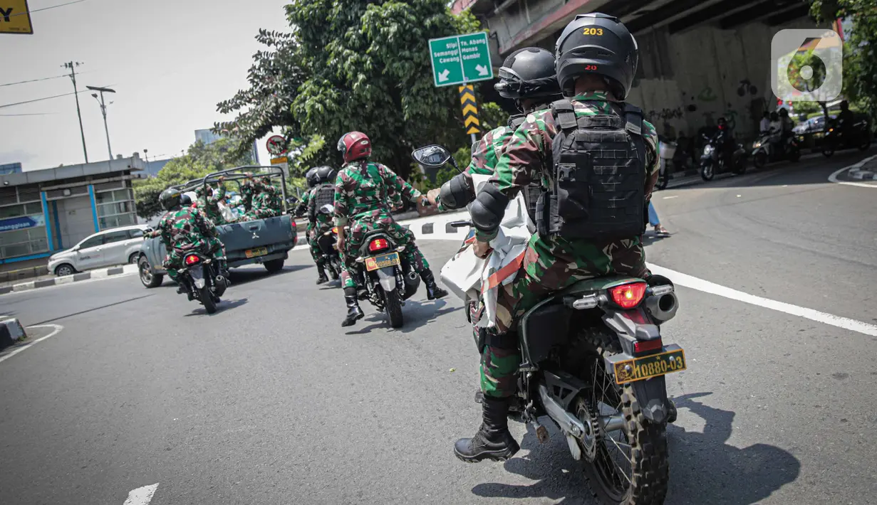 Anggota TNI berpatroli untuk mencopot paksa baliho Rizieq Shihab yang terpasang di sekitar kawasan Petamburan, Jakarta, Jumat (20/11/2020). Pencopotan dilakukan karena menyalahi aturan yang telah ditetapkan. (Liputan6.com/Faizal Fanani)