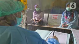 Pasien melakukan pendaftaran saat simulasi vaksin COVID-19 di Puskesmas Tapos, Depok, Jawa Barat, Kamis (22/10/2020). Pemkot Depok menggelar simulasi vaksin COVID-19 dalam rangka persiapan vaksinasi yang rencananya akan dilaksanakan bulan November 2020. (Liputan6.com/Herman Zakharia)