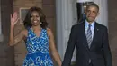 <p>Presiden Amerika Serikat (AS) ke-44, Barack Obama menggandeng tangan sang istri, Michelle Obama, sambil menyapa awak media setibanya pada acara parade di barak marinir AS, Washington, 27 Juni 2014. (AFP PHOTO / SAUL LOEB)</p>