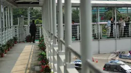 Sejumlah orang menyeberang melalui Jembatan Penyeberangan Orang (JPO)  Bundaran HI, Jakarta, Jumat (20/3/2015). Pemprov DKI akan menjadikan JPO di kawasan Bundaran HI sebagai standar JPO yang ada di Jakarta nanti. (Liputan6.com/Faizal Fanani)