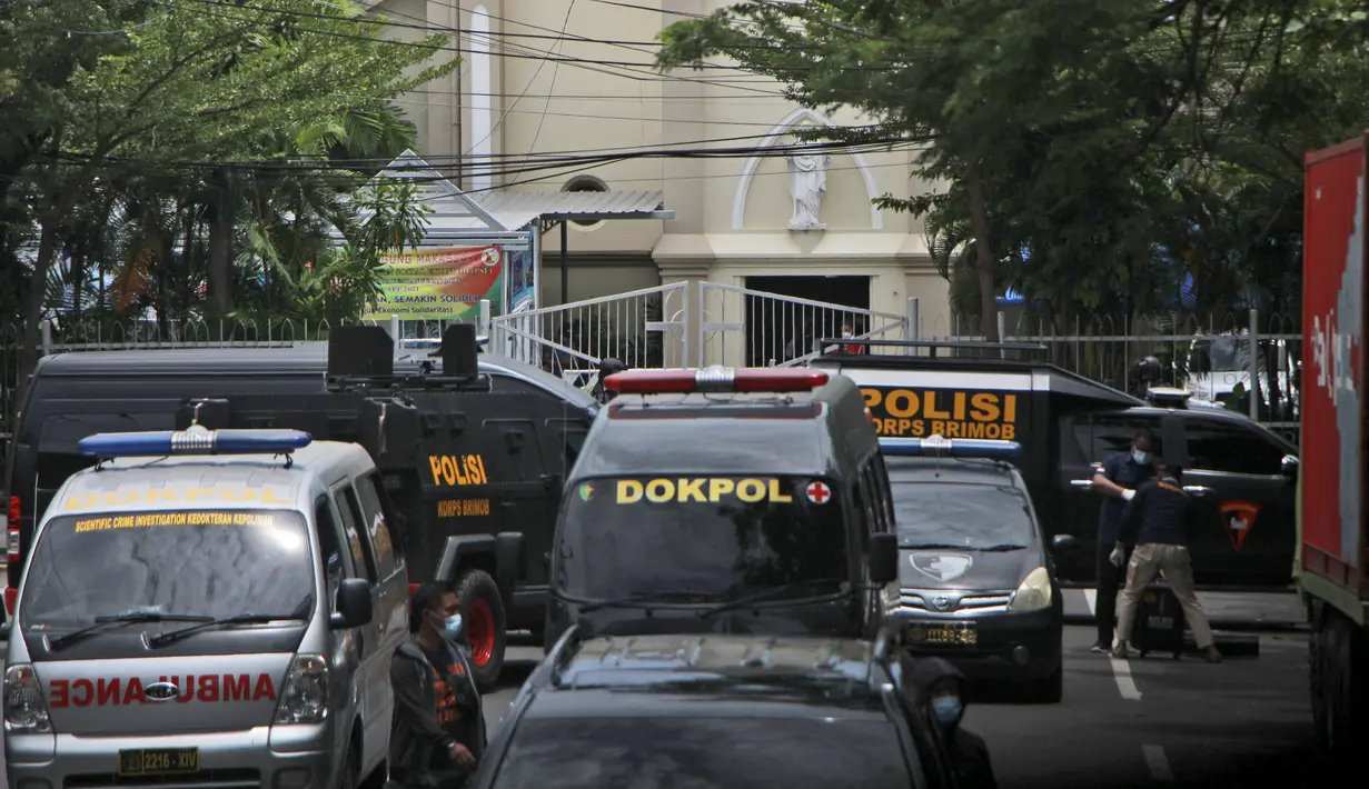Kendaraan polisi diparkir di dekat katedral Katolik tempat ledakan meledak di Makassar, Sulawesi Selatan (28/3/2021). Wilhelminus menerangkan, beberapa jemaat terluka akibat ledakan tersebut. (AP Photo/Masyudi S. Firmansyah)
