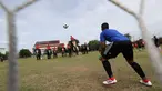 Kiper tim Ayutthaya Wittayalai School mengawasi bola selama pertandingan melawan gajah di sebuah sekolah di Provinsi Ayutthaya, Thailand, Selasa (12/6). Pertandingan digelar sebagai kampanye untuk mempromosikan Piala Dunia 2018. (AP Photo/Sakchai Lalit)