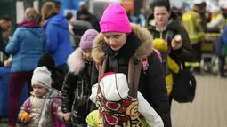 Pengungsi Ukraina berangkat dari perbatasan di Medyka, Polandia tenggara, Rabu (30/3/2022). Menyusul pengumuman Rusia bahwa pasukan mungkin ditarik dari berbagai bagian Ukraina, beberapa pengungsi kembali ke negaranya. (AP Photo/Sergei Grits)