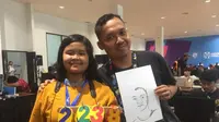 Anak yang mahir membuat sketsa wajah di Asian Para Games 2018, Temanku Lima Benua. (Bola.com)