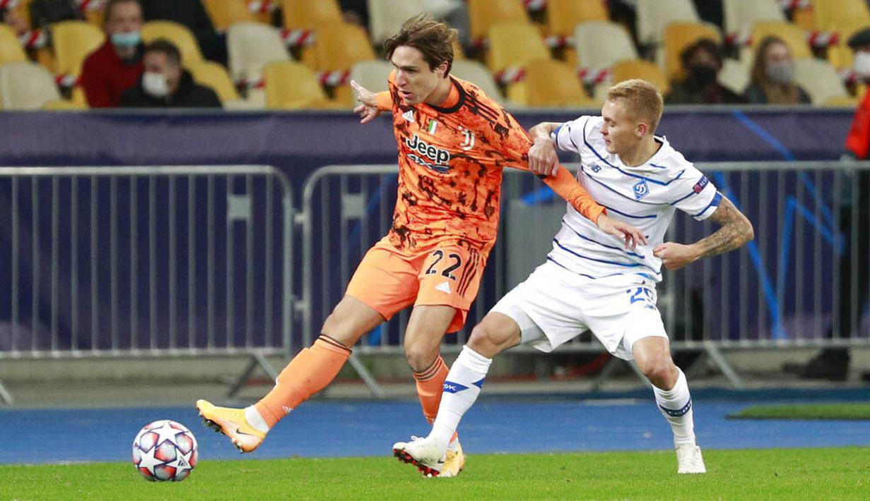 Pemain Juventus, Federico Chiesa, berebut bola dengan pemain Dynamo Kyiv, Vitaliy Buyalskyi, pada laga Liga Champions di Stadion Olimpiyskiy, Rabu (21/10/2020). Juventus menang dengan skor 2-0. (Valentyn Ogirenko/Pool via AP)