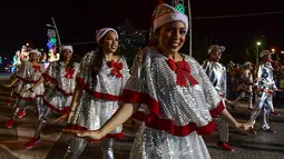 Seorang pria dan wanita bernari merayakan parade  Natal Panama City (16/12). Warga Panama tengah mempersiapkan diri menyambut datangnya Natal 2018 yang jatuh pada tanggal 25 Desember. (AFP Photo/Luis Acosta)