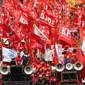 Sejumlah buruh membawa bendera berwarna merah saat aksi May Day 2016 di Jakarta, Minggu (1/5). Kaum buruh mengajukan tuntutan menolak upah murah serta pencabutan PP No. 78 Tahun 2015. (Liputan6.com/Angga Yuniar)