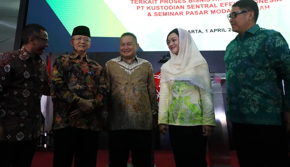 Sekretaris DSN-MUI, Anwar Abbas (kedua kiri) dan Direktur Utama PT Kustodian Sentral Efek Indonesia (KSEI), Friderica Widyasari Dewi (kedua kanan) saat penyerahan fatwa syariah terkait proses Bisnis Atas Layanan Jasa di Gedung Bursa Efek Indonesia, Jakarta, Senin (1/4). (Liputan6.com/Johan Tallo)