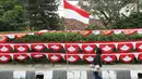 Warga melintas di depan bendera dan aksesori kemerdekaan RI, Jakarta Selatan, Selasa (1/8). Penjualan bendera serta aksesori kemerdekaan ditawarkan dengan harga bervariasi, mulai Rp10ribu hingga Rp250ribu. (Liputan6.com/Immanuel Antonius)