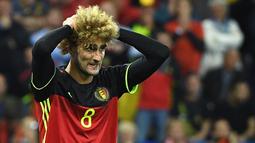 1. Marouane Fellaini (Belgia), gelandang kribo asal klub Manchester United ini tampil dengan rambut yang diwarnai pirang pada ajang Piala Eropa 2016. (AFP/Emmanuel Dunand) 