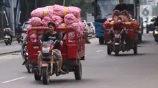 Warga membawa bahan makanan dengan sepeda motor saat melintas di kawasan Tangerang, Banten, Rabu (16/2/2022).Bank Indonesia (BI) memperkirakan terjadi penurunan harga komoditas atau deflasi pada Februari 2022. (Liputan6.com/Angga Yuniar)