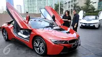 President Director of BMW Group Indonesia Karen Lim (kiri) berbincang dengan pembeli pertama unit mobil hybrid BMW i8 Protonic Red Edition, Sonny Kastara usai penyerahan mobil tersebut di Jakarta, Kamis (20/4).(Liputan6.com/Angga Yuniar)
