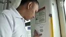 Petugas menunjukkan tombol pemberitahu masinis saat dalam perjalanan, Jakarta, Senin (20/8). Berbagai fasilitas LRT seperti pegangan tangan yang sesuai tinggi badan, hingga tombol keamanan guna menunjang kenyamanan. (Merdeka.com/Iqbal S. Nugroho)