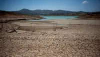 Tanah kering yang terlihat di sekitar waduk Vinuela saat gelombang panas melanda wilayah La Vinuela di Spanyol selatan, Rabu (9/8). Eropa tengah dilanda gelombang panas Lucifer yang suhunya mencapai di atas 40 derajat Celsius. (JORGE GUERRERO / AFP)