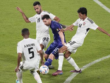 Pemain Timnas Argentina, Lionel Messi dihadang tiga pemain Timnas Uni Emirat Arab (UEA) dalam pertandingan uji coba di Zayed Sports City Stadium, Abu Dhabi, Rabu (16/11/2022) malam WIB. (AP Photo/Hussein Malla)