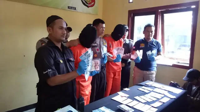 Kepolisian Sektor Kertek, Wonosobo menangkap dua pelaku peredaran uang palsu dan menyita barang bukti uang palsu sejumlah 37.400.000. (Foto: Liputan6.com/Istimewa/Muhamad Ridlo)