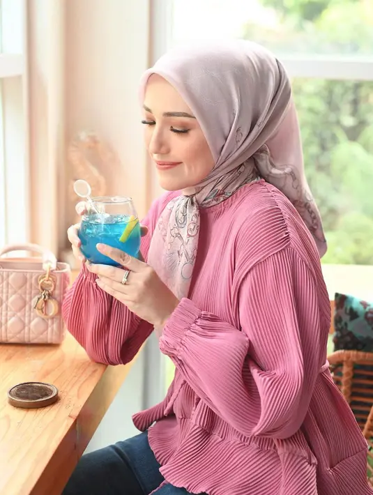 Warna merah muda memang tak pernah salah. Adelia Pasha memadukan atasan pleats berwarna merah muda dnegna celana jeans, dan hijab abu-abu yang serasi. [Foto: Instagram/adeliapasha]
