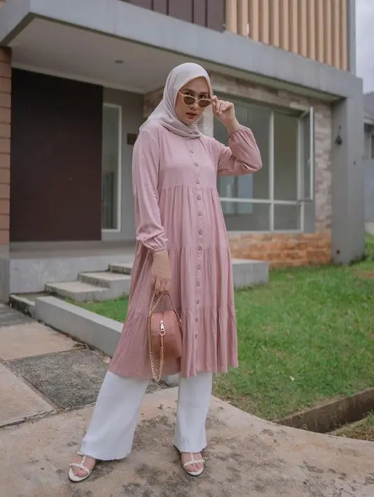 Tampil lebih soft, dengan perpaduan tunik warna pink pastel, hijab warna krem, dan celana kulot warna putih. Manis banget! (Instagram/dwihandaanda).
