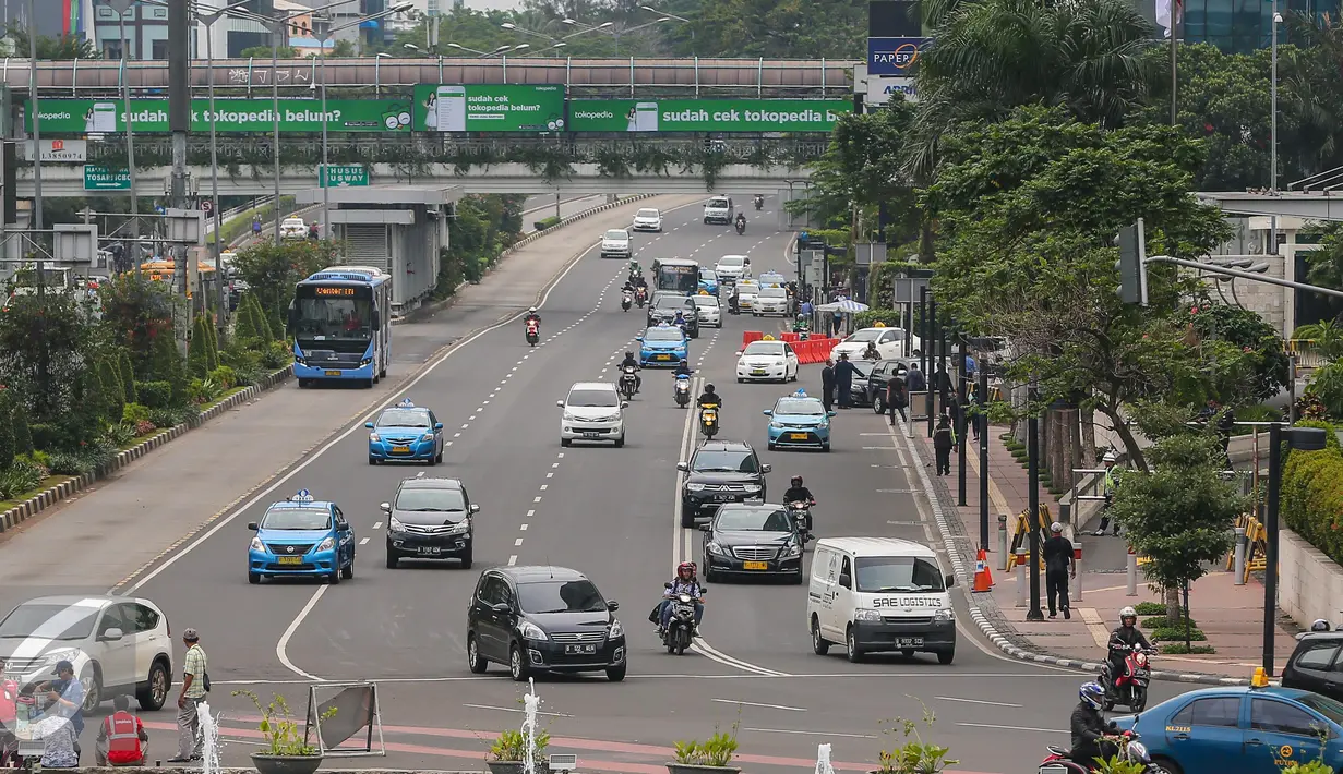 Sejumlah kendaraan melintas di kawasan Jalan Thamrin, Kamis (14/1/2016). Paska teror bom dan penembakan di Sarinah, ruas jalan thamrin lengang. (Liputan6.com/Faizal Fanani)