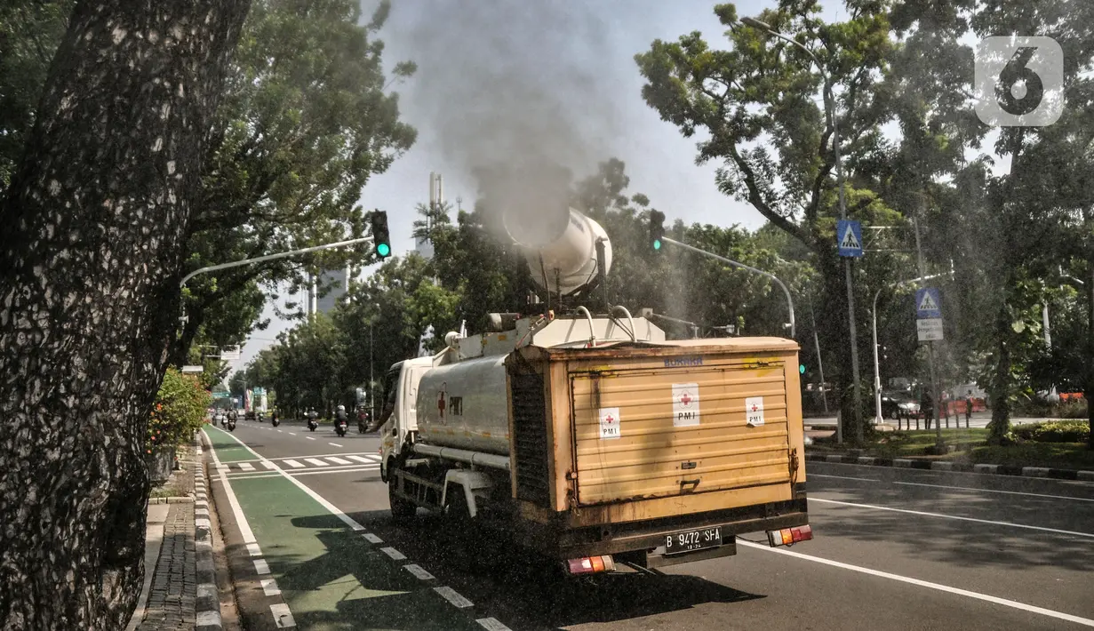 Petugas Palang Merah Indonesia (PMI) menggunakan kendaraan Gunners Spraying saat penyemprotan disinfektan di Jakarta, Selasa (6/7/2021). PMI melakukan penyemprotan disinfektan secara rutin dengan menggunakan kendaraan Gunners Spraying berkapasitas 5.000 liter. (merdeka.com/Iqbal S. Nugroho)