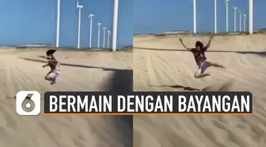 Video seorang pria bermain dengan bayangan kincir angin raksasa viral di media sosial.