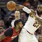 Pemain Cleveland Cavaliers, LeBron James (23) memberikan umpan melewati adangan pemain Miami Heat, James Johnson (16) pada lanjutan NBA basketball game, di Quicken Loans Arena, Cleveland, (28/11/2017). Cavs menang 108-97. (AP/Tony Dejak)