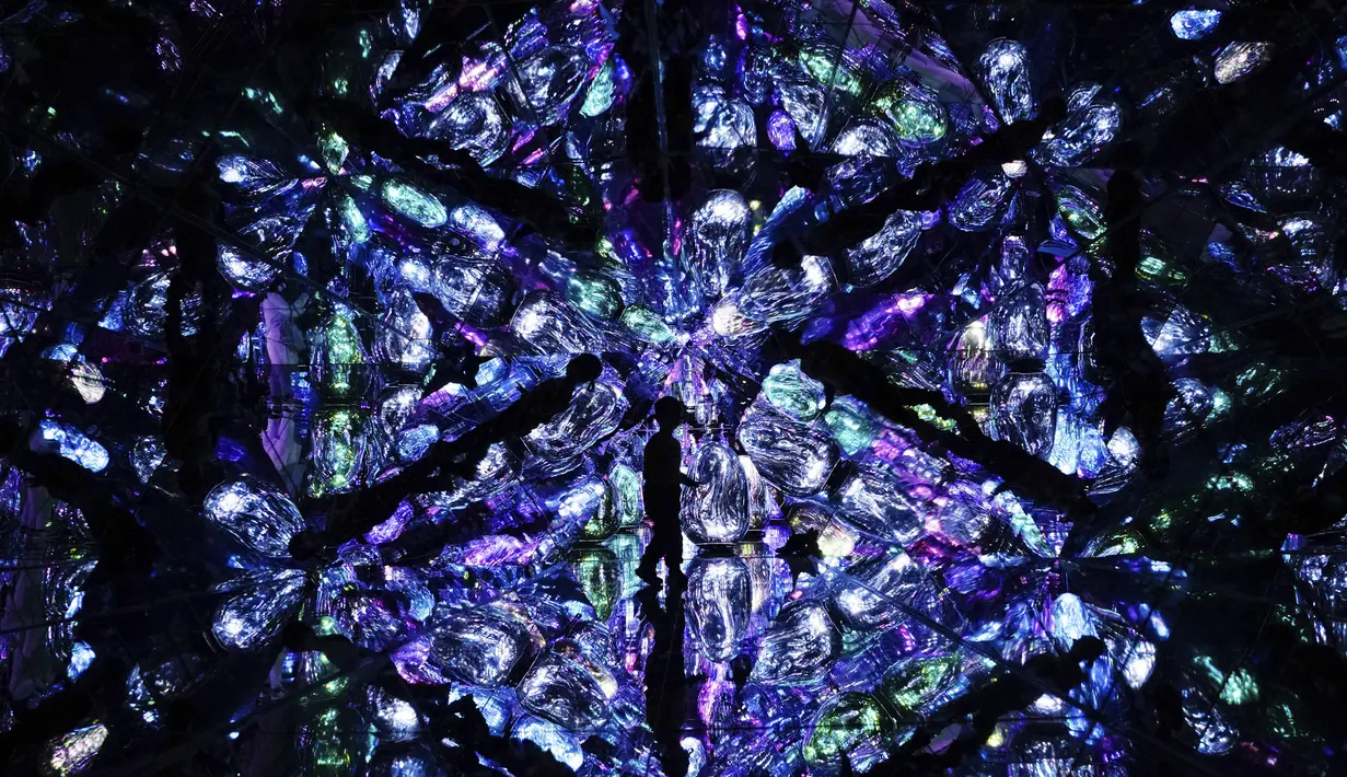 Siluet seorang anak saat berjalan melalui instalasi seni digital berjudul "Resonating Microcosms, Solidified Light Color" di museum "teamLab Massless" yang baru dibuka di Beijing, China, Senin (26/12/2022). Berbasis di Tokyo teamLab membuat museum seni digital yang memamerkan berbagai karya seni interaktif di dalam pusat perbelanjaan di ibu kota Beijing. (AP Photo/Andy Wong)