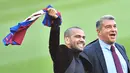 Bek baru Barcelona Dani Alves (kanan) dan presiden FC Barcelona Joan Laporta menyapa fans saat menghadiri upacara presentasi di stadion Camp Nou di Barcelona (17/11/2021). Dani Alves akan mengenakan nomor punggung 8 yang pernah di pakai Andreas Iniesta. (AFP/Pau Barrena)
