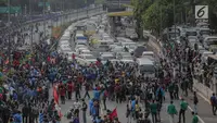 Massa mahasiswa memblokade Tol Dalam Kota saat berunjuk rasa di depan Gedung DPR/ MPR RI, Jakarta, Selasa (24/9/2019). Unjuk rasa menuntut penolakan atas pengesahan sejumlah RUU kontroversial tersebut diwarnai aksi bakar sejumlah kardus di tol dalam kota. (Liputan6.com/Faizal Fanani)