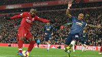 Gelandang Manchester United, Ashley Young, menghalau umpan gelandang Liverpool, Naby Keita, pada laga Premier League di Stadion Anfield, Liverpool, Minggu (16/12). Liverpool menang 3-1 atas MU. (AFP/Paul Ellis)