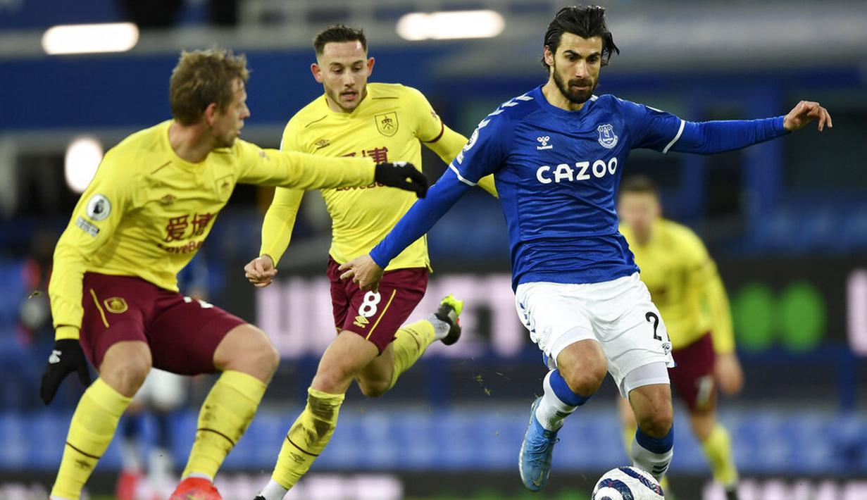 Pemain Everton, Andre Gomes, berusaha melewati pemain pemain Burnley, Matej Vydral, pada laga Liga Inggris di Stadion Goodison Park, Sabtu (13/3/2021). Burnley menang dengan skor 2-1. (Gareth Copley/Pool via AP)